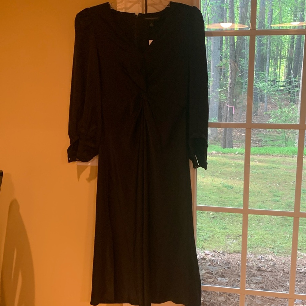 Very cute puff sleeve knotted waist dress. Black satin in size 2 Brand new